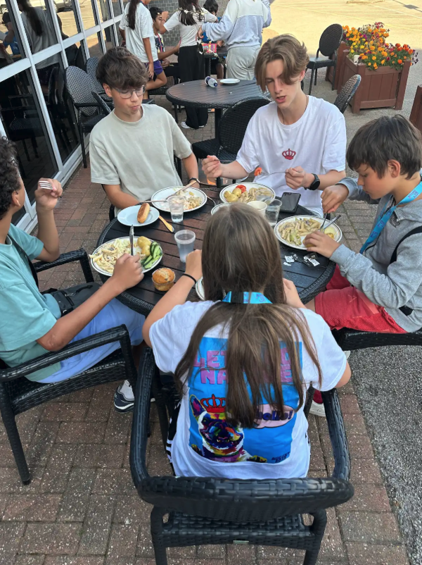 Campers eating together on outdoor terrace