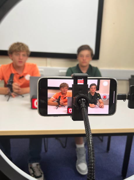 Teens filming video content with phone and ring light